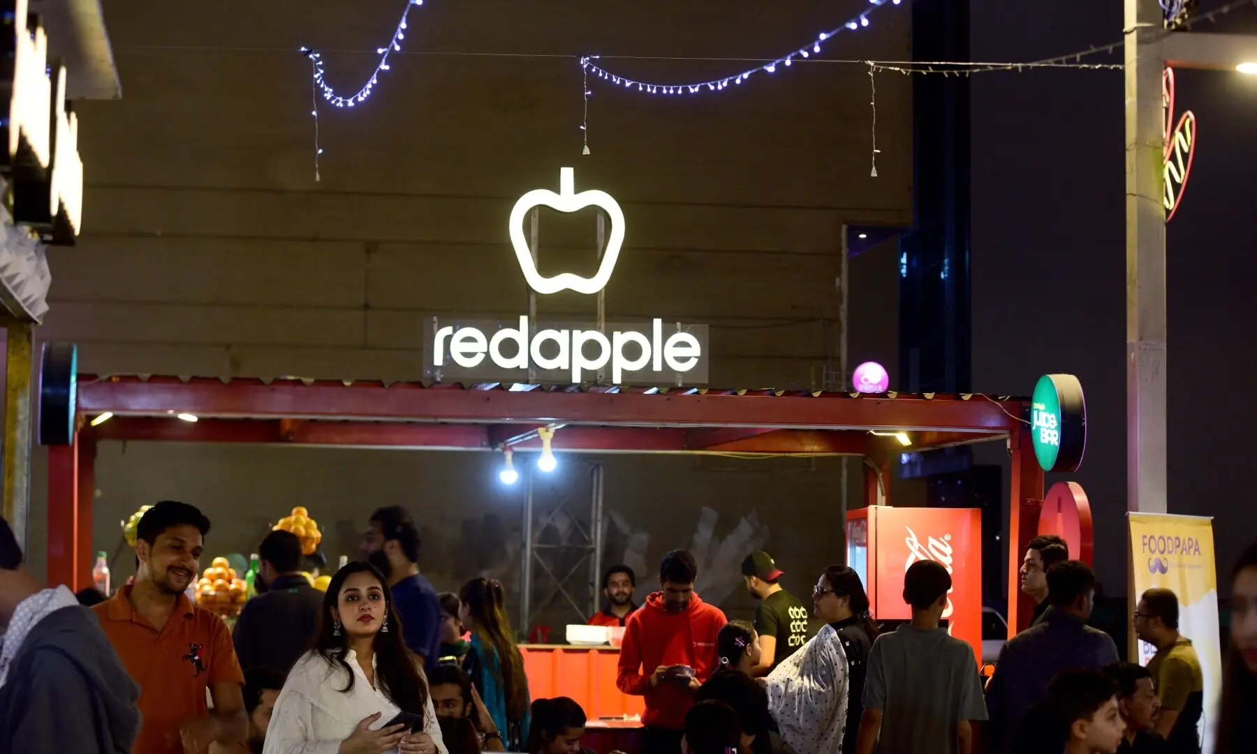 Customers gather around a food stall at a Karachi&rsquo;s Creek Walk food street, enjoying the open air on a winter evening in Karachi.  &mdash; Tahir Jamal/White Star