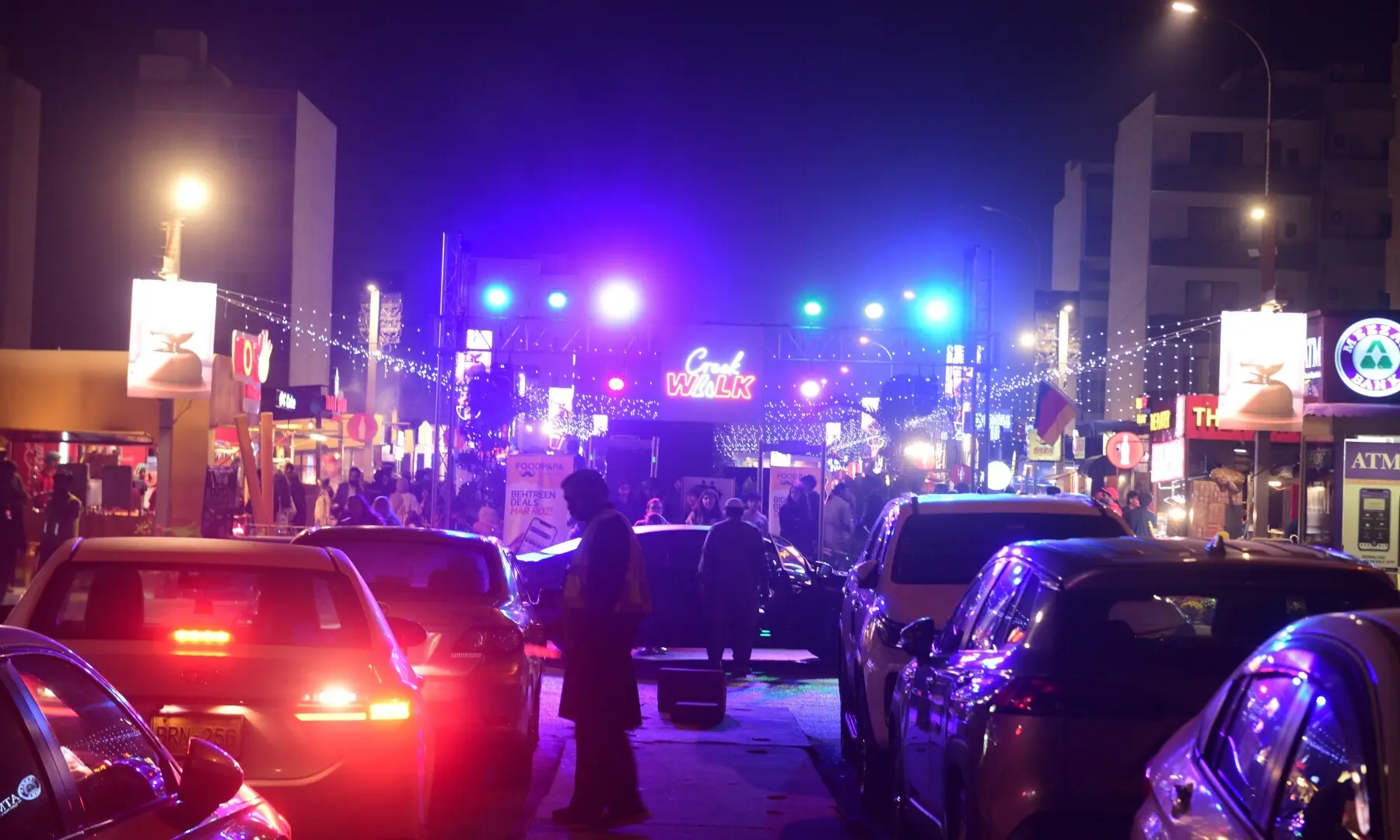 People park their cars outside the well-lit entrance to the Creek Walk Food Street in DHA Phase 8. &mdash; Tahir Jamal/White Star