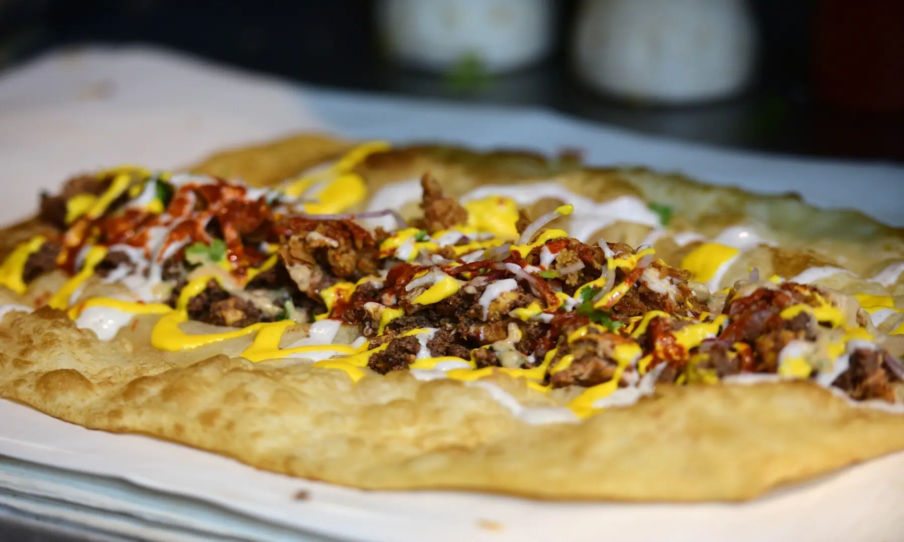 A chicken roll is being prepared at Burns Road, layered with mayo and chutney. &mdash; Tahir Jamal/White Star