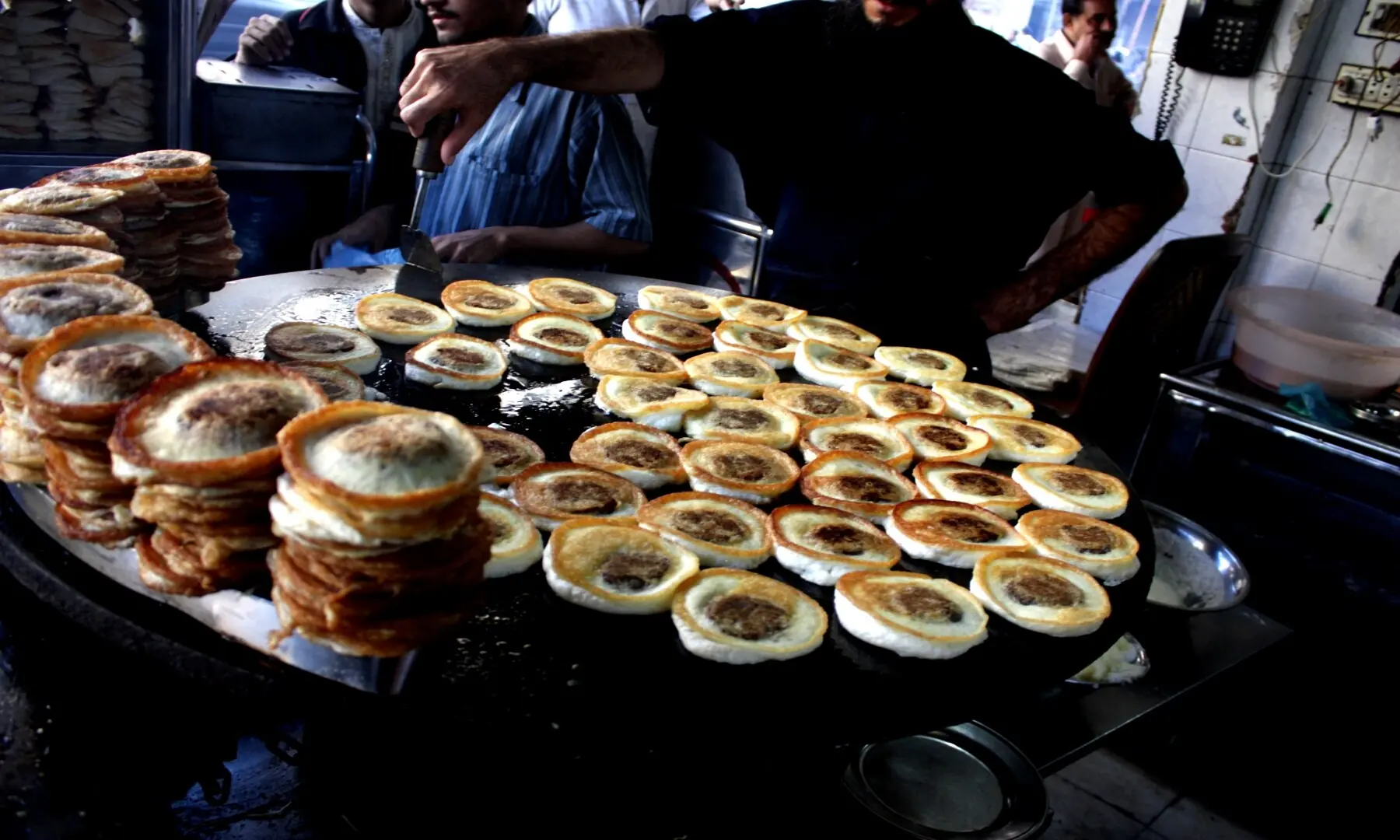 A vendor skillfully prepares bun kebabs at Burns Road, one of Karachi&rsquo;s iconic street foods loved for its spicy patties, tangy chutneys, and soft buns. &mdash; Hussain Afzal/White Star