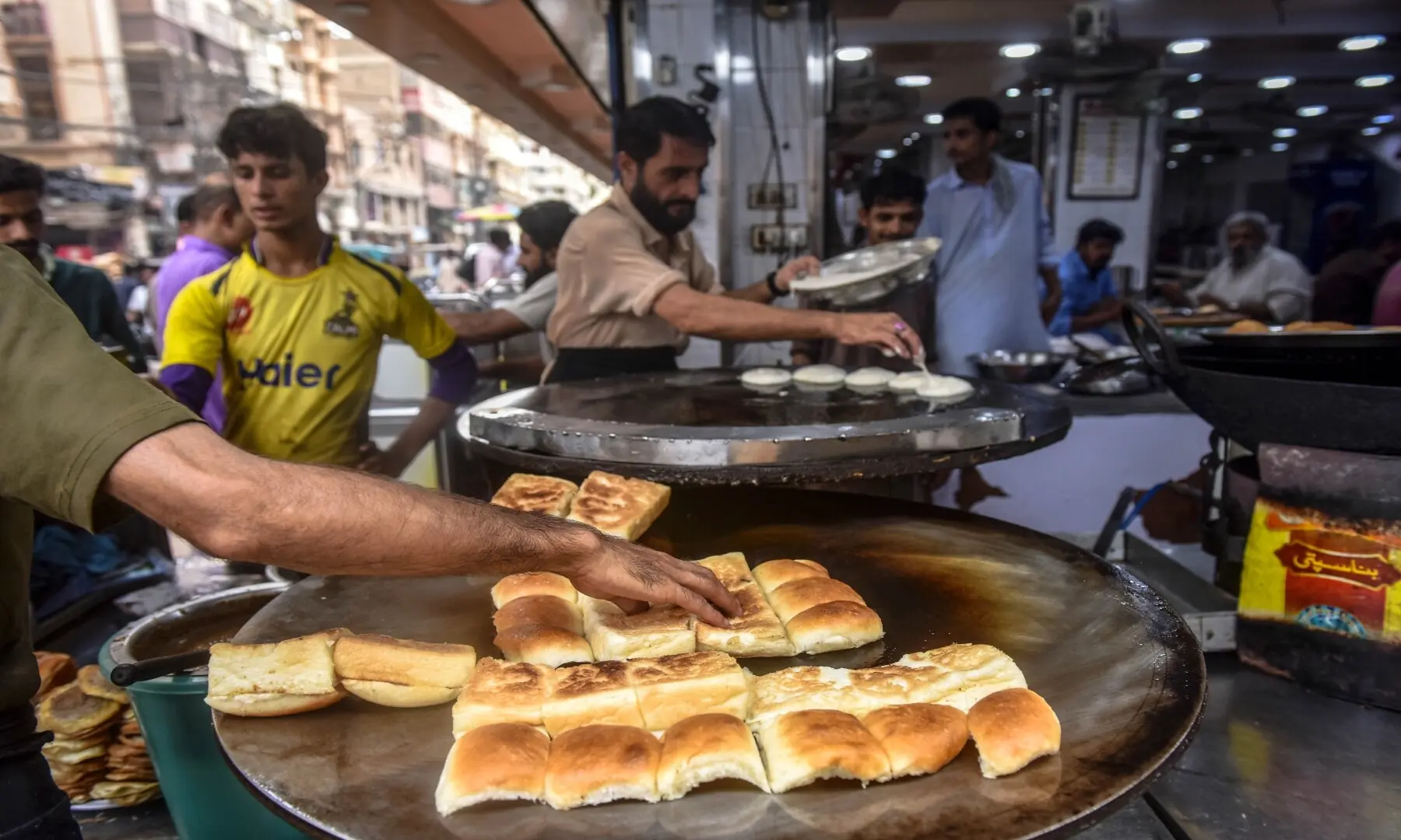 Bun kebabs being prepared at Burns Road, spicy patties layered with chutney and onions, a quintessential snack for Karachiites. &mdash; Fahim Saddique/White Star