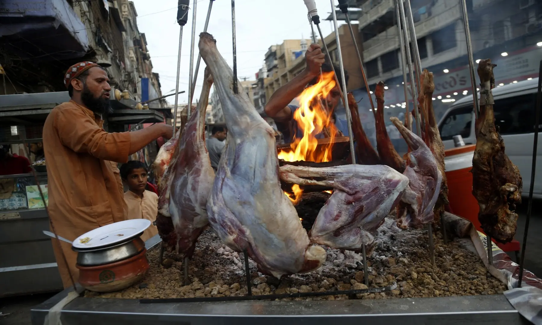 A vendor prepares a mutton sajji at Burns Road Food Street, a rich and succulent dish grilled with spices that has become a favourite for Karachiites seeking hearty, flavoursome food. &mdash; Shakil Adil/White Star