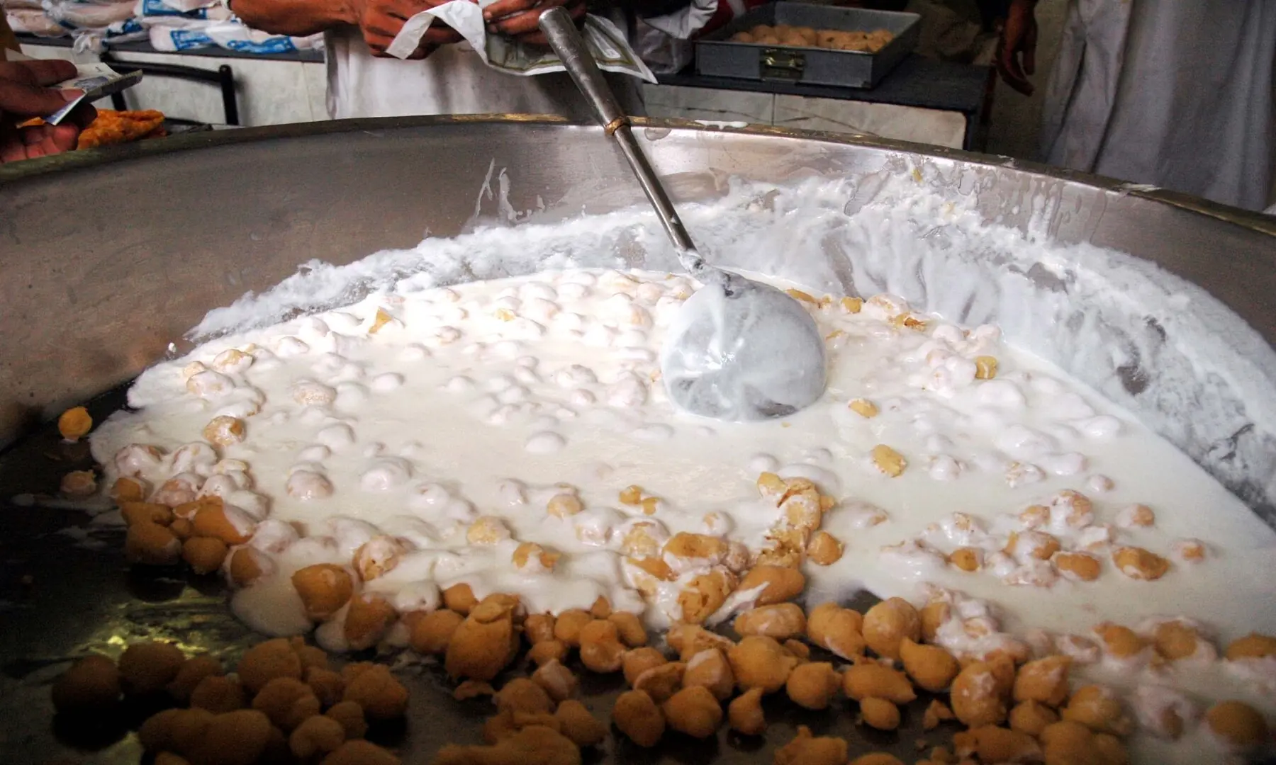 Dahi phulki being prepared in a large vessel at Burns Road, a tangy, yogurt-based snack that is a favourite among Karachiites for its refreshing flavours. While it&rsquo;s mostly popular in Ramazan, people of the city love to try it throughout the year. &mdash; Fahim Siddique/White Star