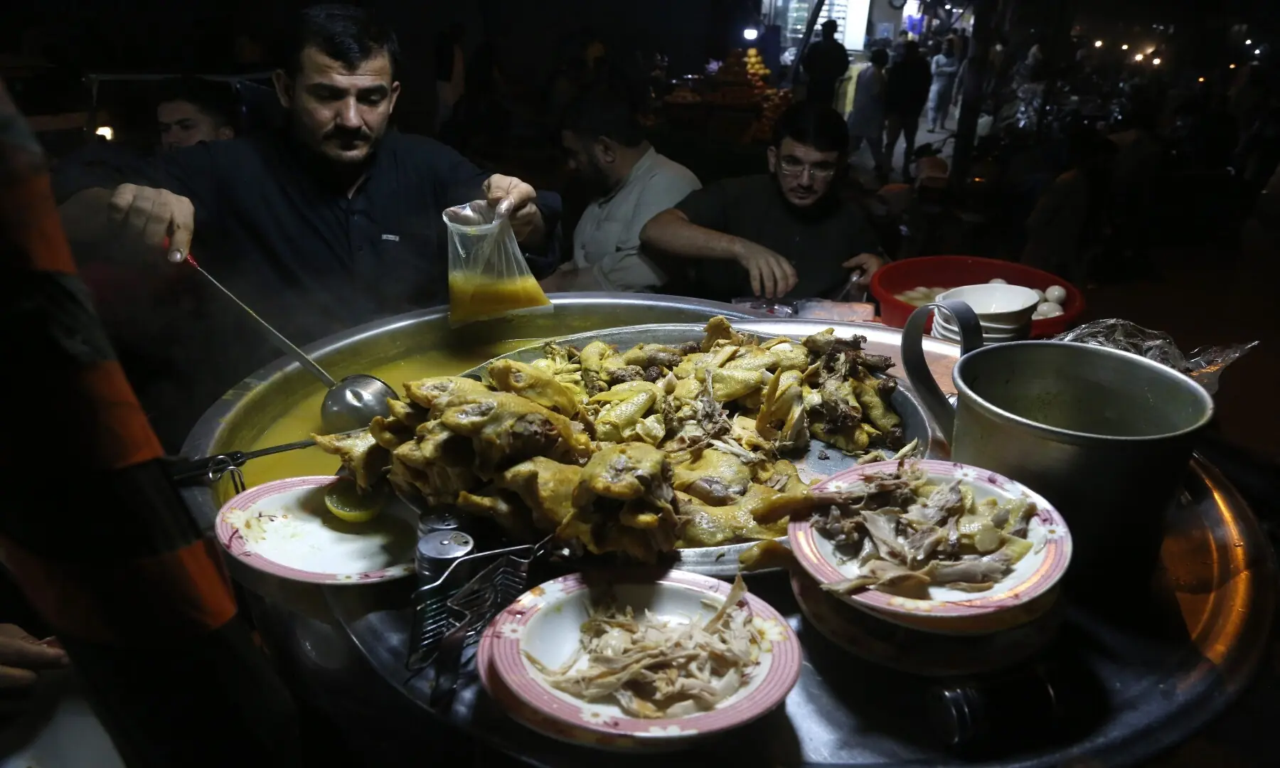 Street-style chicken soup being prepared at Burns Road, simmering with aromatic spices and tender meat, a comforting late-night favourite for Karachiites during winter months. &mdash; Fahim Saddique/White Star