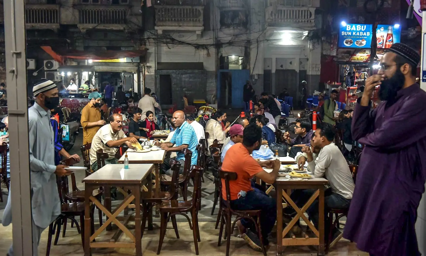 A view of the crowded Burns Road on a Friday night, bustling with food lovers enjoying Karachi&rsquo;s iconic street eats. &mdash; Fahim Siddiqi/White Star