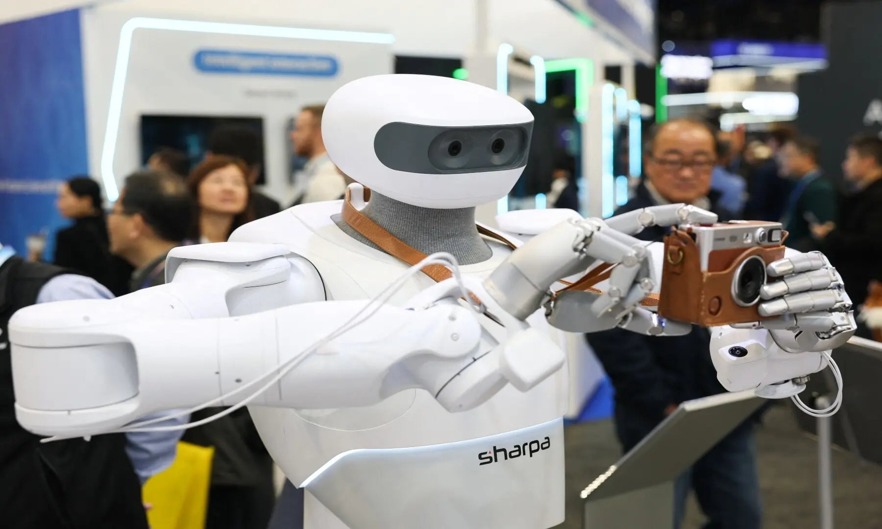 The Sharpa robot takes a photograph with a Fujifilm instax camera during the annual Consumer Electronics Show (CES) in Las Vegas, Nevada on January 6, 2026. &mdash; Patrick T. Fallon / AFP