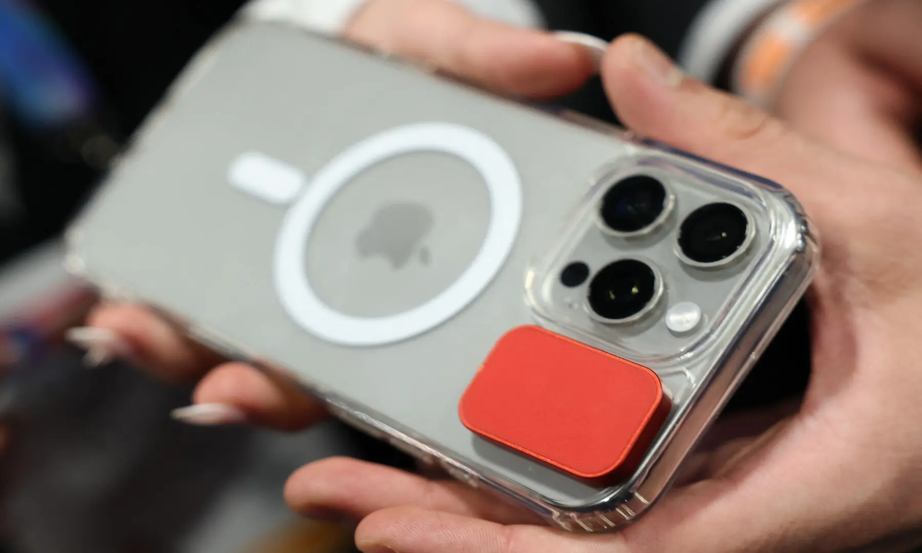 A Solver magnetic button is attached to an Apple iPhone during CES Unveiled ahead of the Consumer Electronics Show (CES) in Las Vegas, Nevada on January 4, 2026. &mdash; Patrick T. Fallon / AFP