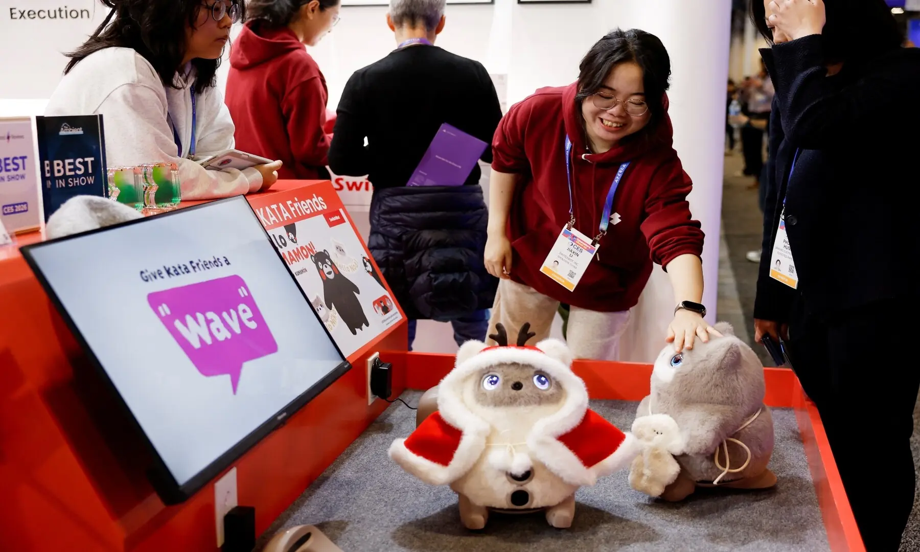 Attendees look at SwitchBot&rsquo;s KATA Friends, AI companions with a camera nose that is designed to interact with users through voice, gestures, and cloud AI, at the annual Consumer Electronics Show (CES) in Las Vegas, Nevada, on January 6, 2026. &mdash; Patrick T. Fallon / AFP