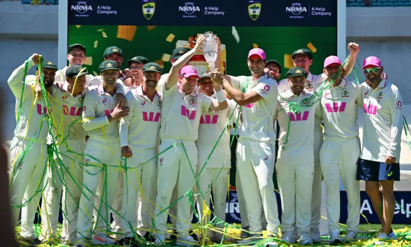 Australian players celebrate with the Waterford Crystal Ashes Trophy at the end of the fifth Ashes cricket Test between Australia and England at Sydney Cricket Ground on January 8, 2026. &mdash; AFP