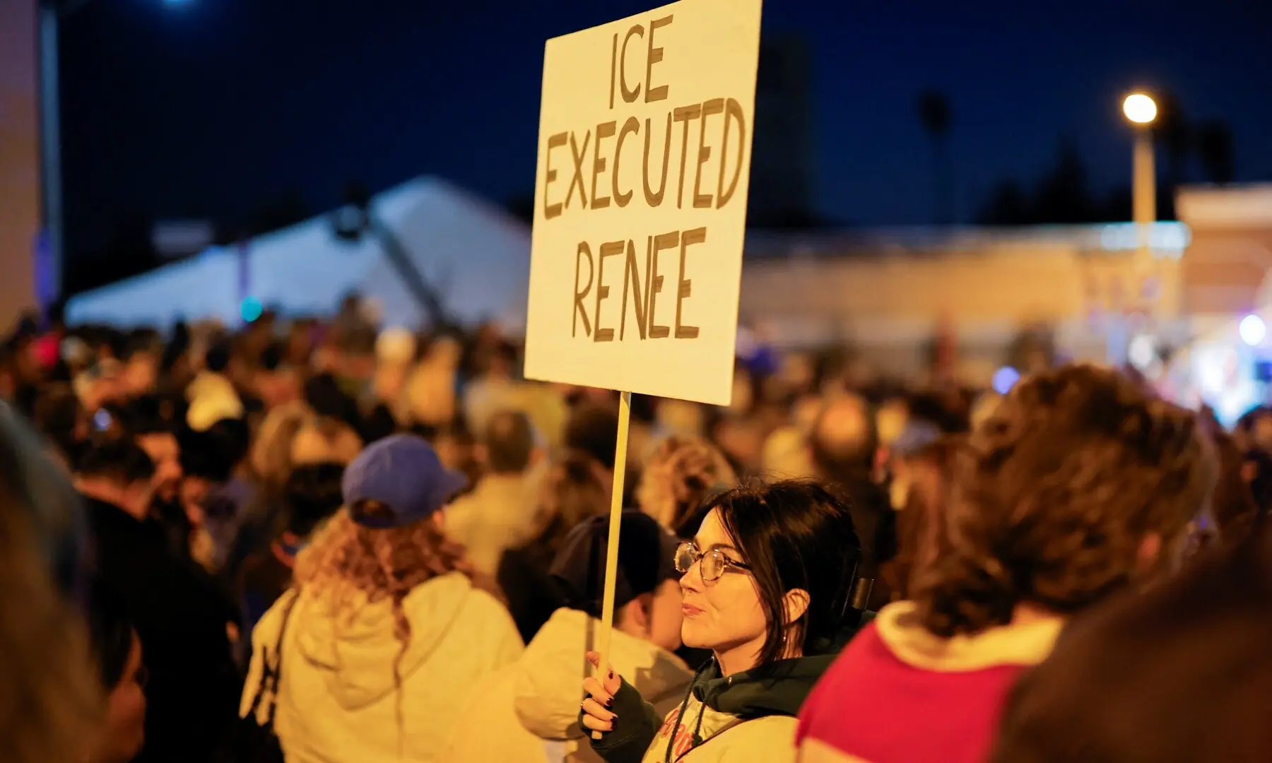 A person holds a sign following the death of Renee Nicole Good, a 37-year-old woman who was shot in her car by a US immigration agent, in Altadena, California, US,, January 7, 2026. —Reuters