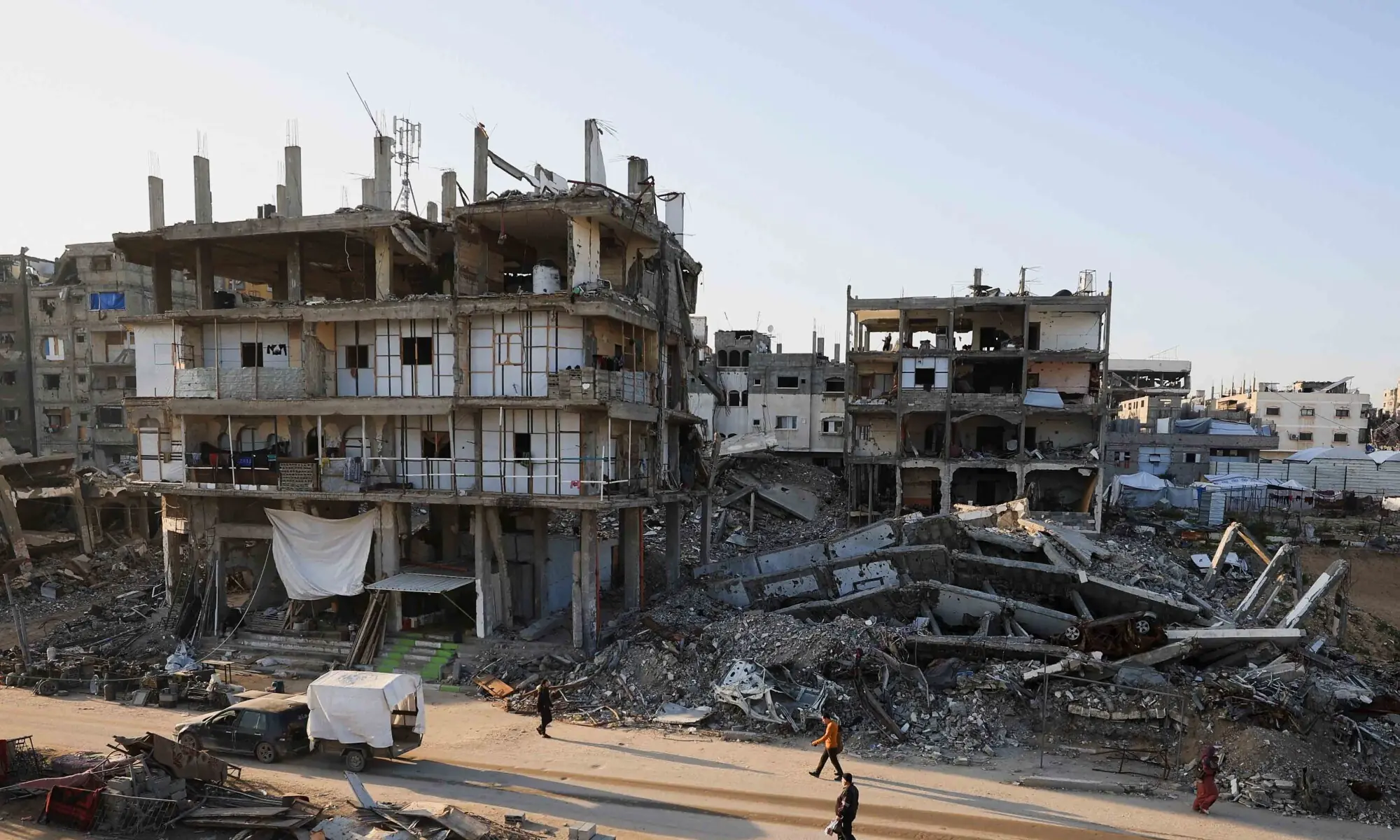 Palestinians walk past destroyed buildings in a neighbourhood heavily damaged during the war, in Gaza City, January 5, 2026. — Reuters Palestinians walk past destroyed buildings in a neighbourhood heavily damaged during the war, in Gaza City, January 5, 2026. — Reuters