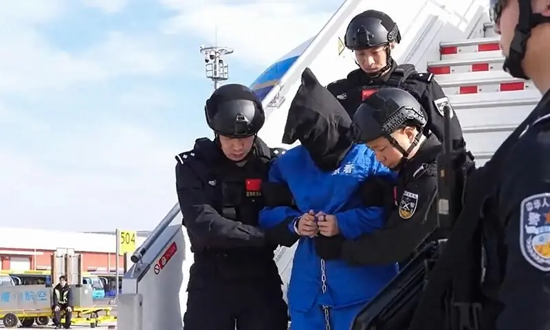 This frame grab taken from undated handout video footage released by China’s Ministry of Public Security on January 8, 2026 shows guards escorting handcuffed accused scam boss Chen Zhi (C) off a China Southern plane in Beijing. — AFP This frame grab taken from undated handout video footage released by China’s Ministry of Public Security on January 8, 2026 shows guards escorting handcuffed accused scam boss Chen Zhi (C) off a China Southern plane in Beijing. — AFP