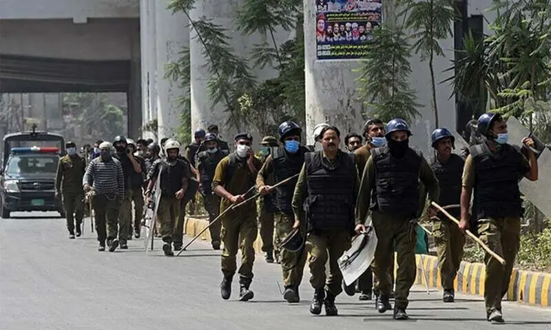 Policemen arrive at the site of a protest by the supporters of the banned Tehreek-i-Labbaik Pakistan (TLP) along a blocked street during a demonstration in Lahore. &mdash; AFP/File