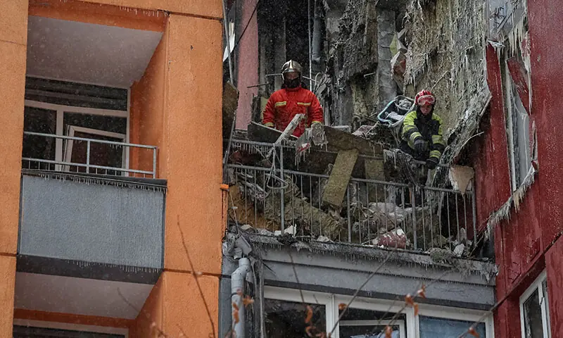 Rescuers work at the site of the apartment building hit by a Russian drone strike in Kyiv, Ukraine on January 9. — Reuters