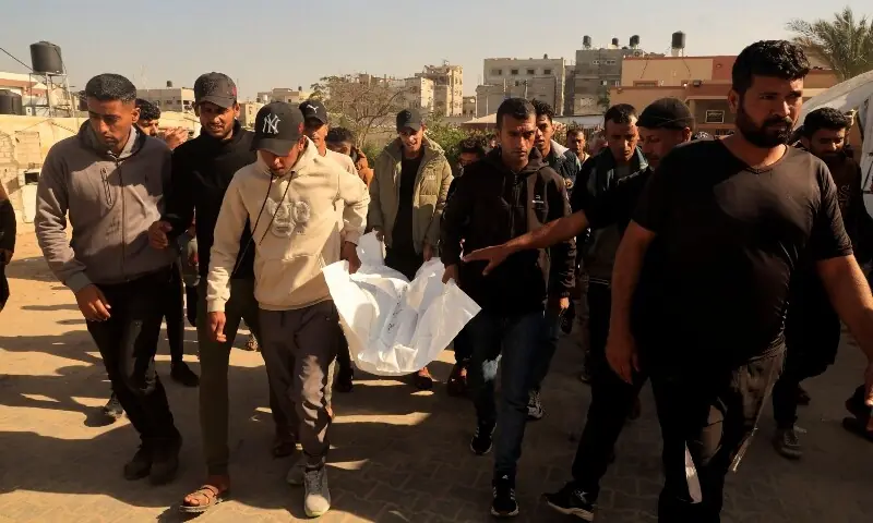 Mourners carry the body of a Palestinian who, according to medics, was killed in Israeli strikes on Thursday, outside Nasser Hospital in Khan Younis in the southern Gaza Strip, January 9. &mdash;Reuters