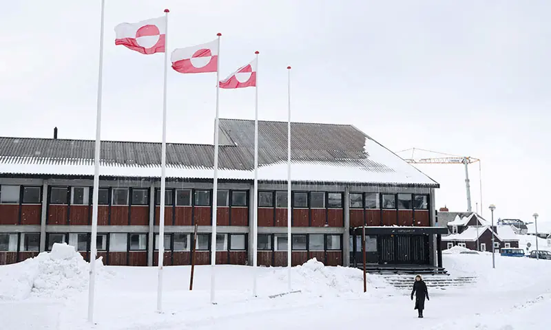 A woman walks past Greenland&rsquo;s parliament Inatsisartut in Nuuk, Greenland on March 28, 2025. &mdash; Reuters/File