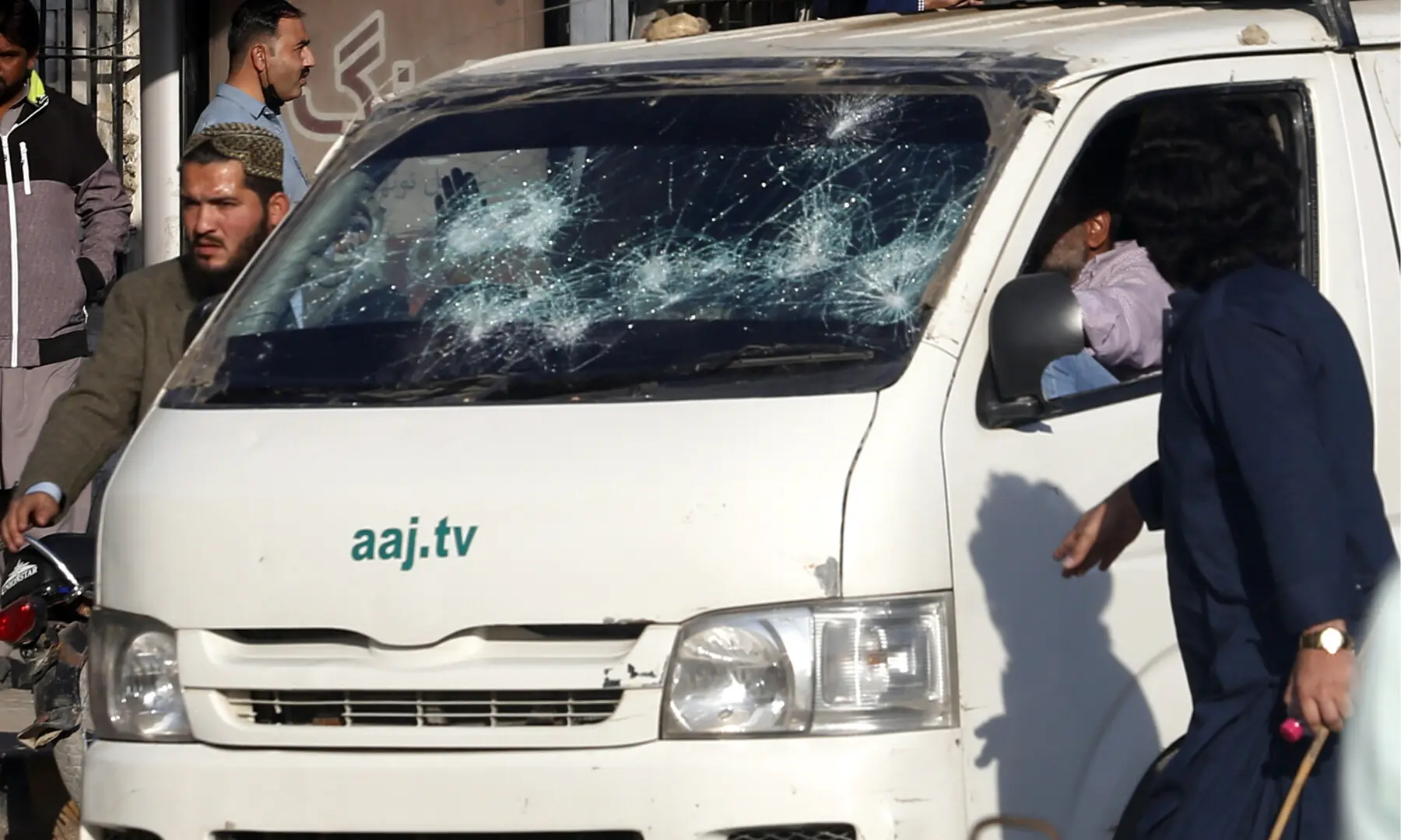  A vehicle of Aaj News with a badly damaged windshield. — Shakil Adil/ White Star 