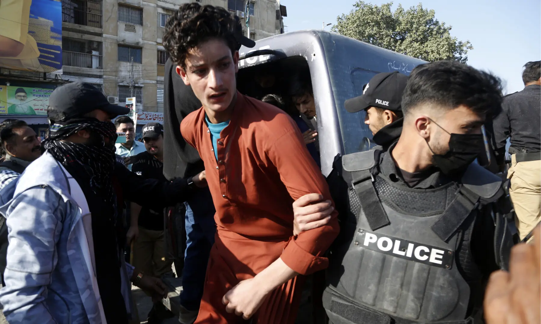 Police detain a PTI supporter gathered near Numaish Chowrangi, Karachi ahead of a PTI rally, on Jan 11, 2026. — Shakil Adil/White Star