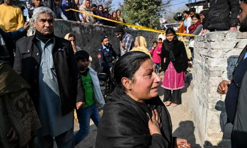 Mourners react after the death of their relatives following a gas cylinder explosion in a Christian colony in Islamabad on January 11. &mdash; AFP