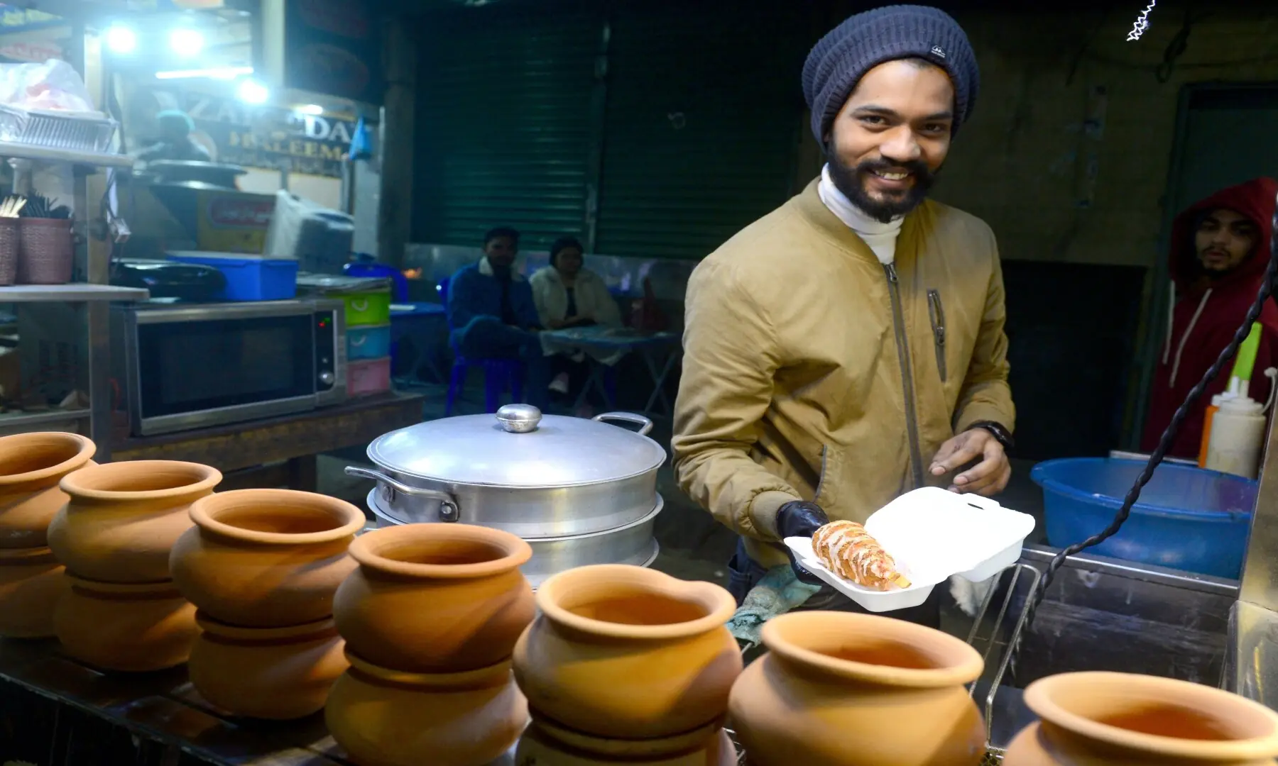 A vendor smiles as he serves matka chai at his stall in Hussainabad, a nod to Karachi&rsquo;s beloved chai culture where tea is more than a drink: it&rsquo;s a ritual and a social moment. &mdash; Tahir Jamal/White Star