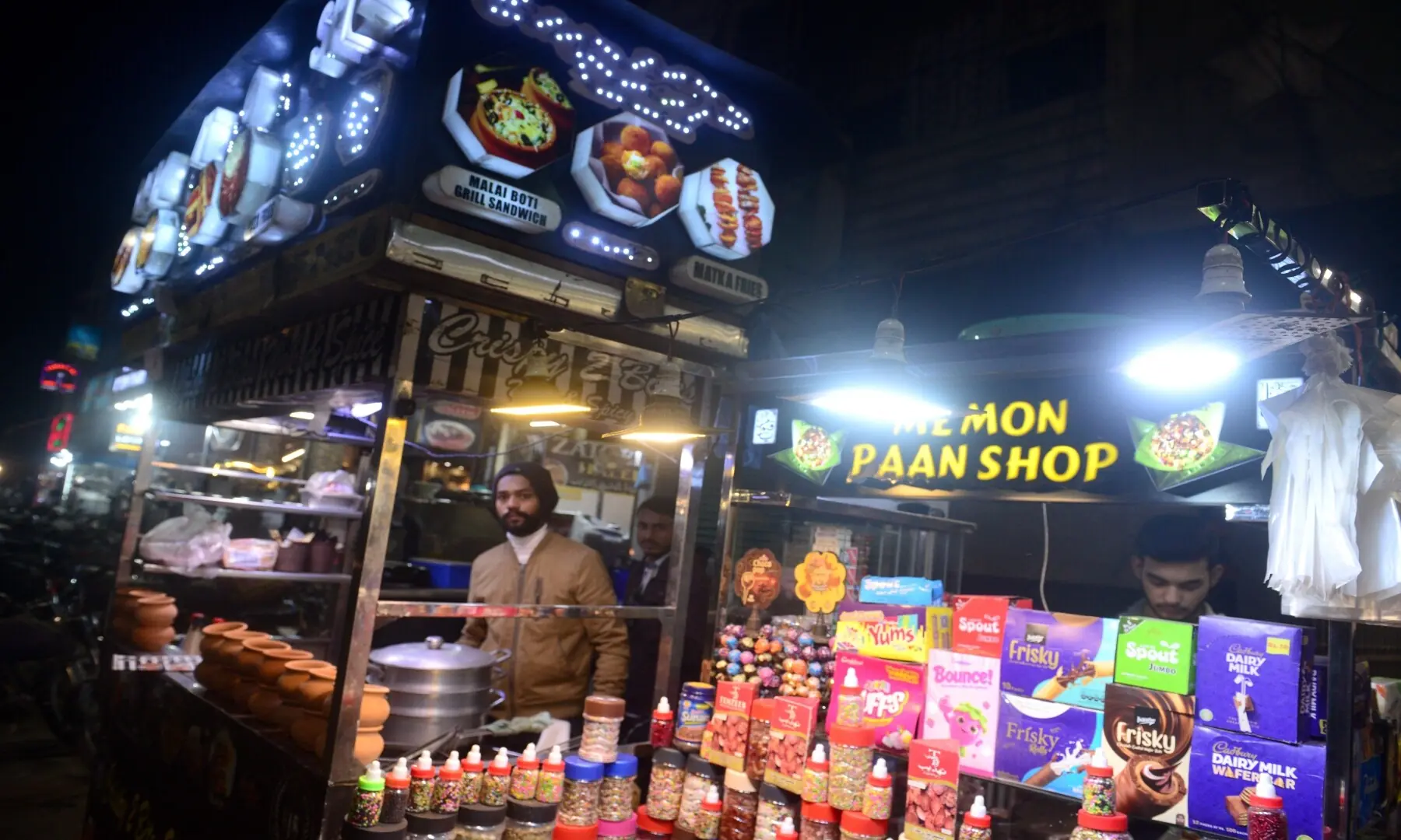 A colourful paan kiosk next to a matka chai stall at Hussainabad Food Street, also selling chocolates, showing the area&rsquo;s mix of traditional treats and modern snacks. &mdash; Tahir Jamal/White Star