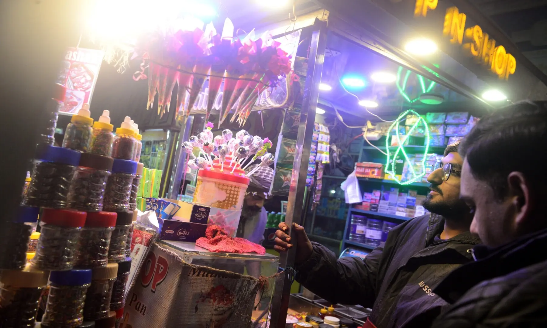 Customers gather at a paan kiosk in Hussainabad, enjoying the city&rsquo;s colourful paan culture. &mdash; Tahir Jamal/White Star