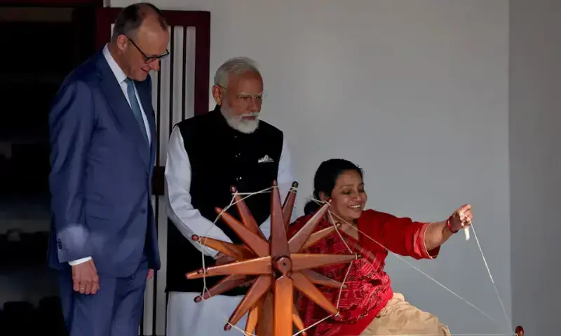 German Chancellor Friedrich Merz and India&rsquo;s Prime Minister Narendra Modi watch as a woman spins cotton on a wheel during their visit to Gandhi Ashram in Ahmedabad, India, January 12, 2026. &mdash; Reuters