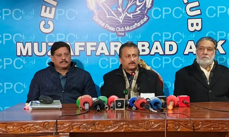 PTI&rsquo;s information secretary Syed Azhar Gillani (centre) speaks at a press conference in Muzaffarabad on Jan 12. &mdash; photo by author