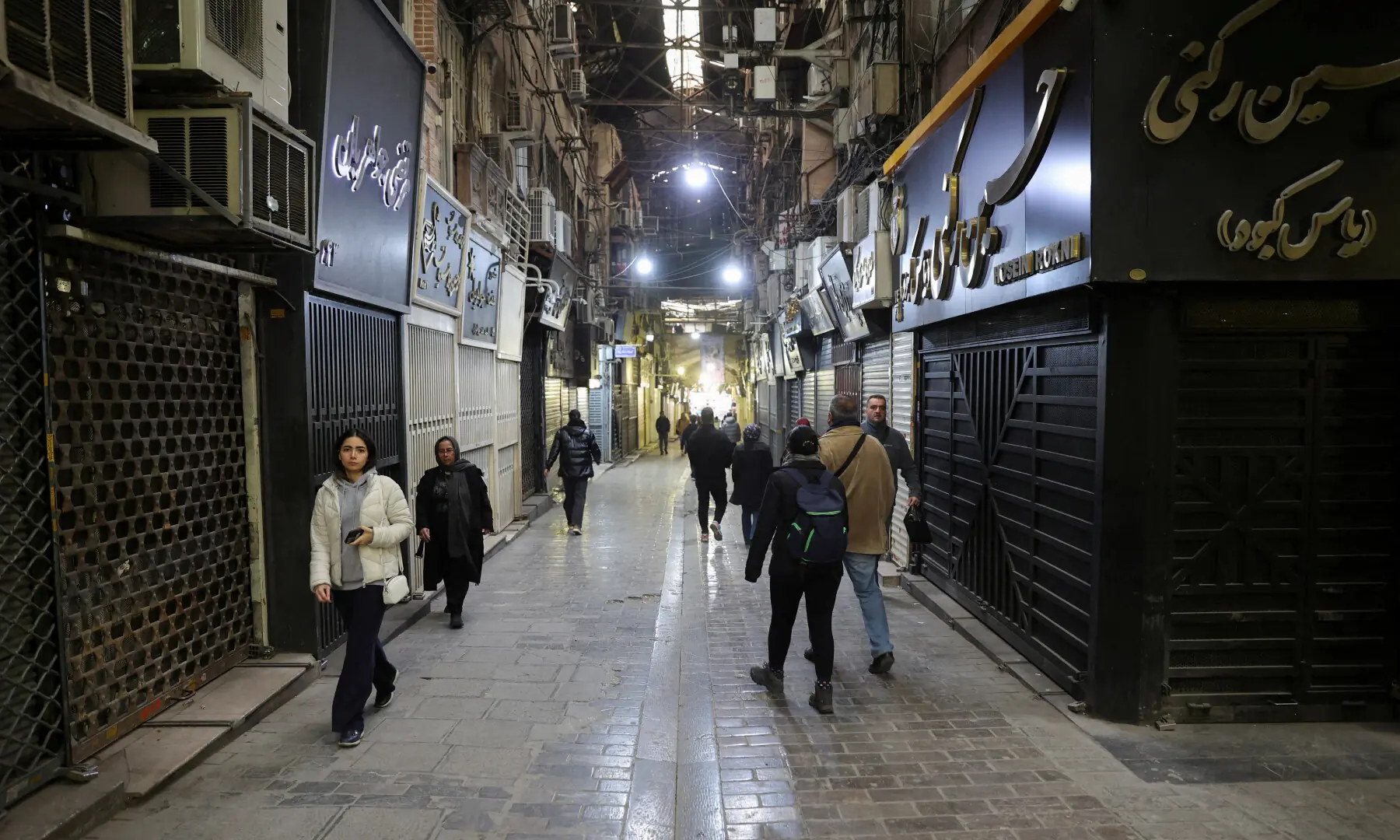 People walk past closed shops, following protests over a plunge in the currency&rsquo;s value, in the Tehran Grand Bazaar in Tehran, Iran on Jan 15, 2026. &mdash; West Asia News Agency via Reuters