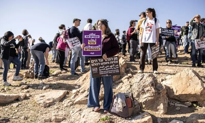 A women holds-up placards during a demonstration against the expulsion of a Bedouin community in Ein al-Auja, near the city of Jericho in the Israel-occupied Palestinian West Bank on January 16, 2026, following Israeli settler violence. —AFP A women holds-up placards during a demonstration against the expulsion of a Bedouin community in Ein al-Auja, near the city of Jericho in the Israel-occupied Palestinian West Bank on January 16, 2026, following Israeli settler violence. —AFP