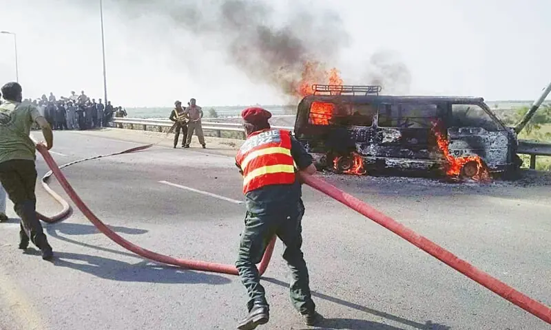 In this file photo, rescue workers try to extinguish the fire which engulfed the van in Multan.— INP In this file photo, rescue workers try to extinguish the fire which engulfed the van in Multan.— INP