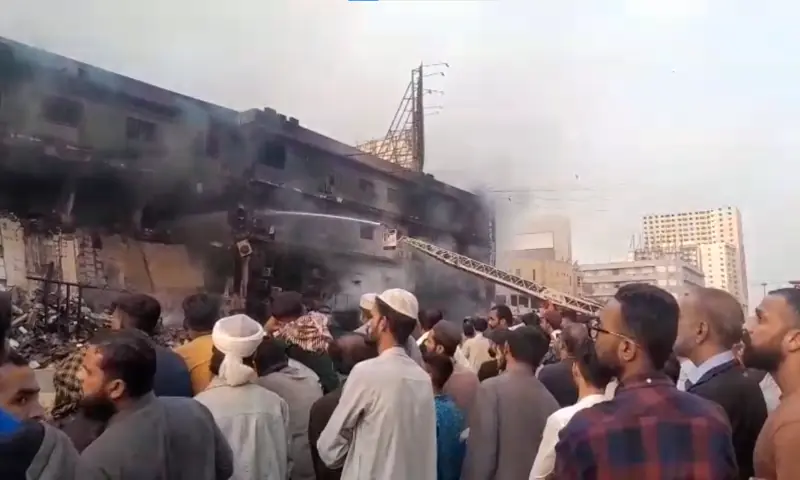 People gather outside Gul Plaza at Karachi’s MA Jinnah Road on Jan 18, 2026 as efforts continue to douse a fire at the mall. — screengrab from video via Imtiaz Ali People gather outside Gul Plaza at Karachi’s MA Jinnah Road on Jan 18, 2026 as efforts continue to douse a fire at the mall. — screengrab from video via Imtiaz Ali