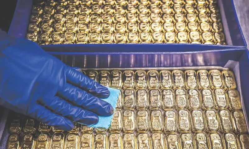 A worker polishes gold bullion bars at the ABC Refinery in Sydney on Wednesday.—AFP A worker polishes gold bullion bars at the ABC Refinery in Sydney on Wednesday.—AFP
