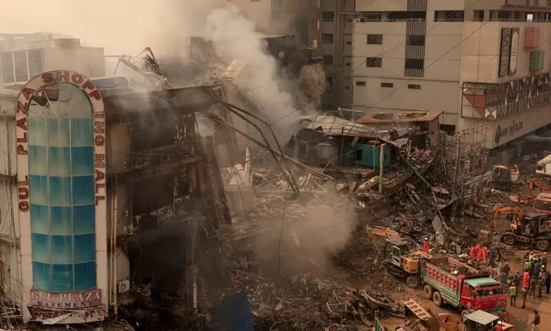 Workers remove debris following a massive fire that broke out in the Gul Plaza Shopping Mall in Karachi on January 19, 2026. &mdash; Reuters