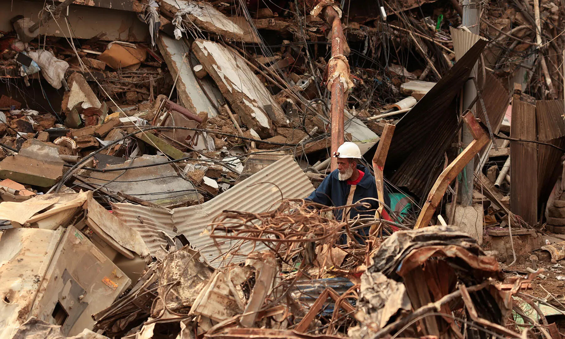  A rescue worker searches for survivors amid the rubble of Karachi’s Gul Plaza shopping mall on January 19, after a massive fire broke out. — Reuters 