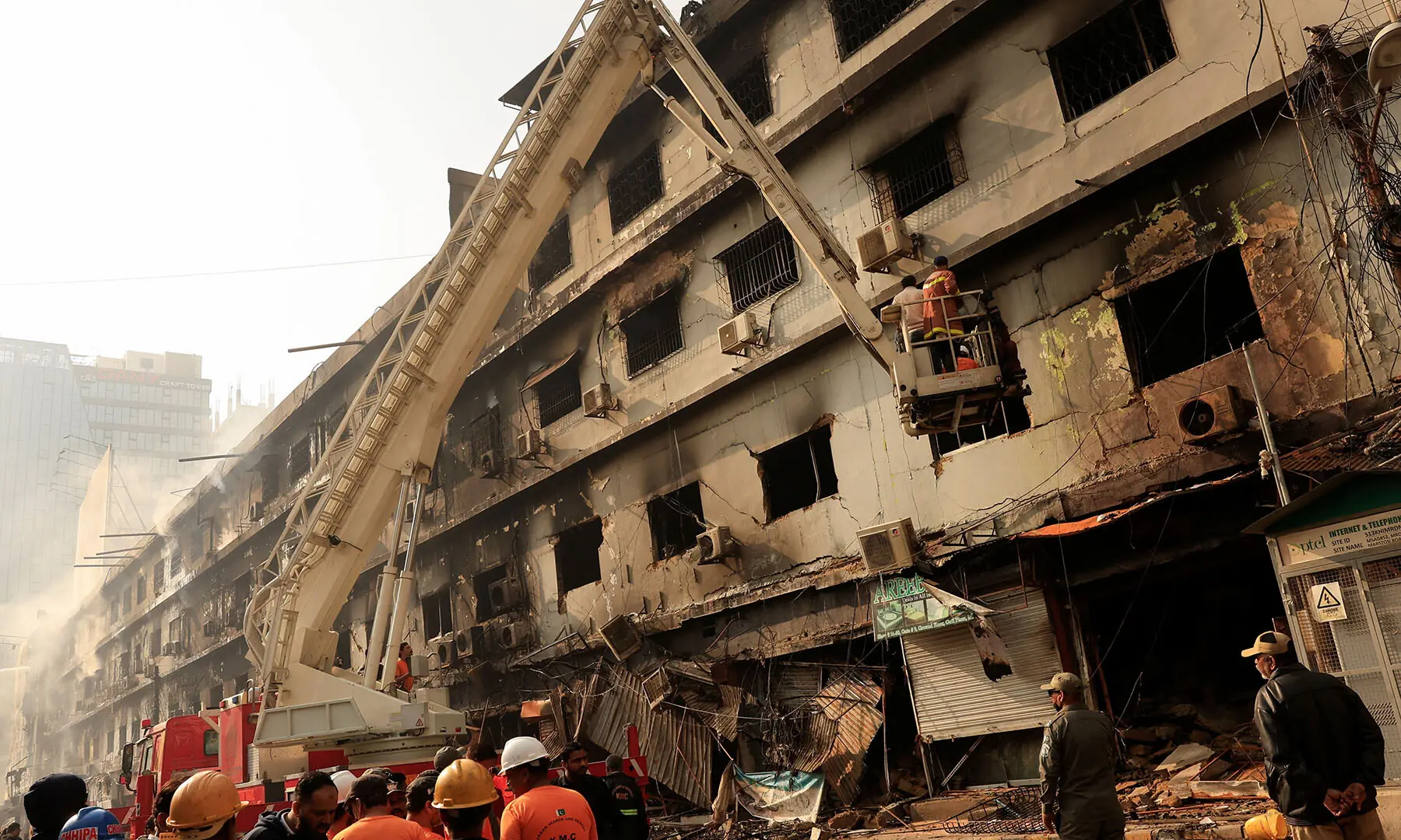  Rescue workers search for victims on January 19, following a massive fire that broke out in Karachi’s Gul Plaza Shopping Mall. — Reuters 