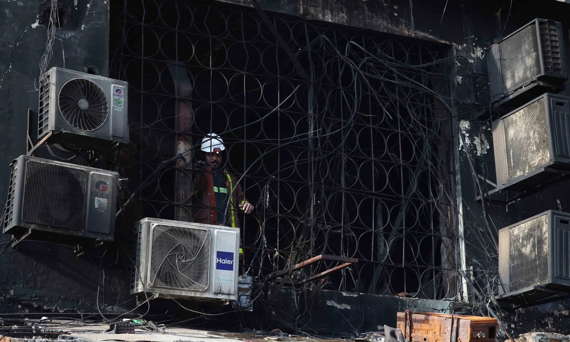 A rescue worker takes a pause while searching for survivors, following a massive fire that broke out in the Gul Plaza Shopping Mall in Karachi, January 19, 2026. &mdash; Reuters