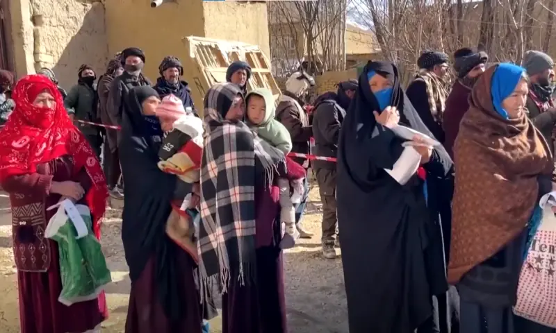 Women hold their children as they wait in line for food in Afghanistan amid a hunger crisis. &mdash; screengrab from video via Reuters