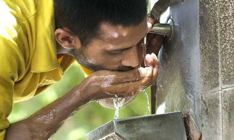 Image shows a person drinking water. — APP/File Image shows a person drinking water. — APP/File