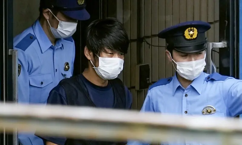 Tetsuya Yamagami, suspected of killing former Japanese premier Shinzo Abe, is escorted by police officers as he is taken to prosecutors, at Nara-nishi police station in Nara, western Japan, in this photo taken by Kyodo July 10, 2022. &mdash; Reuters/File
