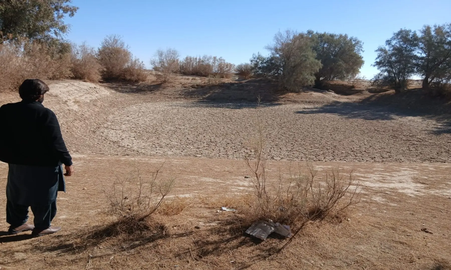 A man standing beside a dried pond in the Daak village of Balochistan&rsquo;s of Nushki, which has been affected by repeated spells of drought since 1997. &mdash; Akbar Notezai
