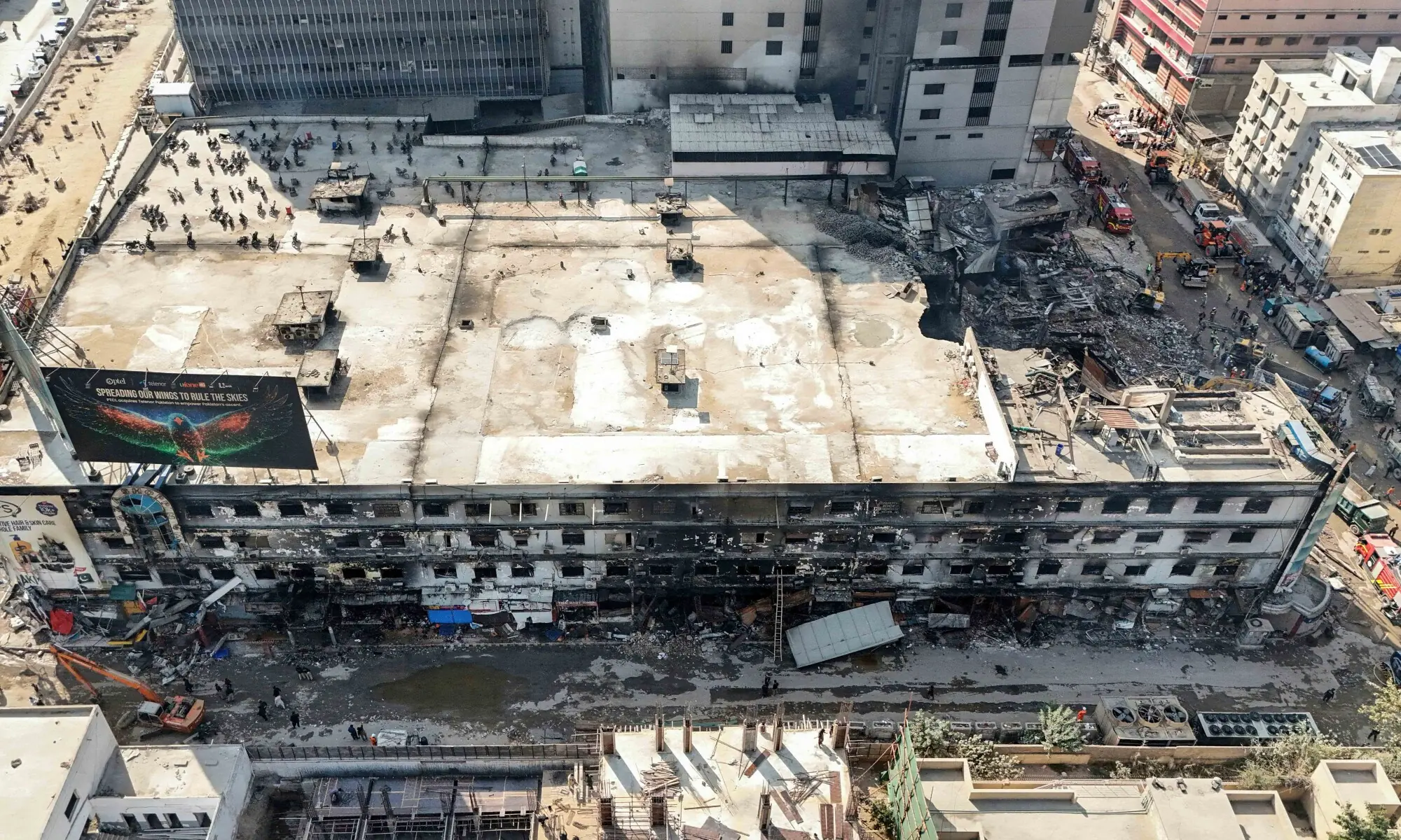 An aerial view shows the charred remains of a shopping mall after a massive fire in Karachi on January 21. &mdash; AFP