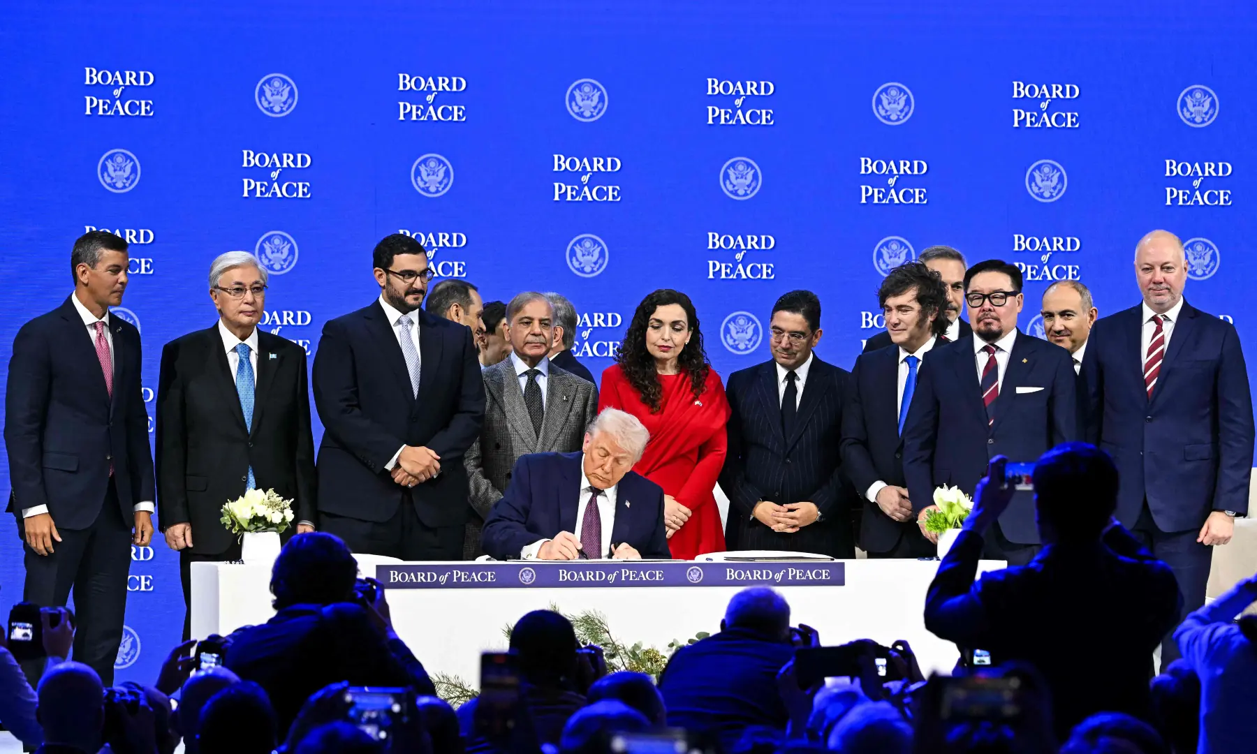 Prime Minister Shehbaz Sharif and others pose with US President Donald Trump signing the founding charter at the &ldquo;Board of Peace&rdquo; meeting during the World Economic Forum (WEF) annual meeting in Davos on Jan 22, 2026. &mdash; AFP