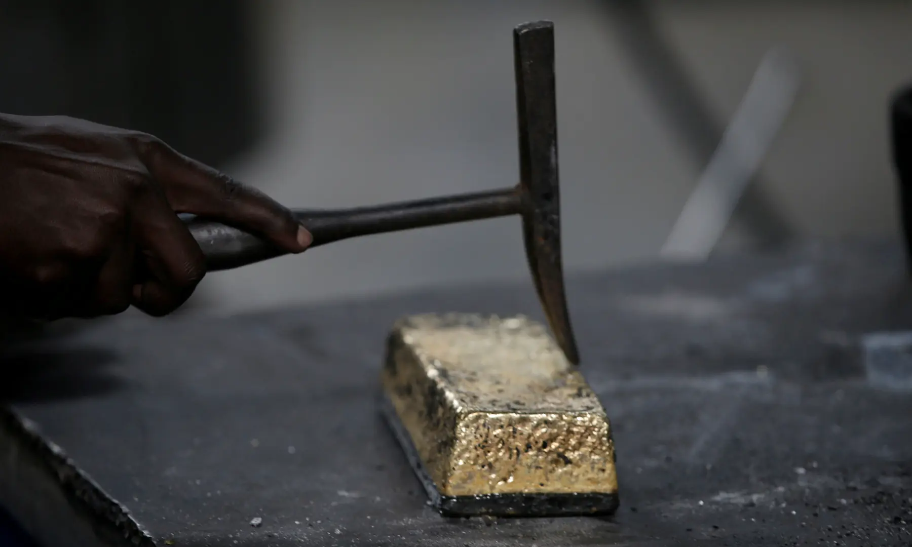 An employee uses a hammer to clean a gold ingot during the refining process at AGR (African Gold Refinery) in Entebbe, Uganda, October 4, 2018 — REUTERS/File Photo An employee uses a hammer to clean a gold ingot during the refining process at AGR (African Gold Refinery) in Entebbe, Uganda, October 4, 2018 — REUTERS/File Photo