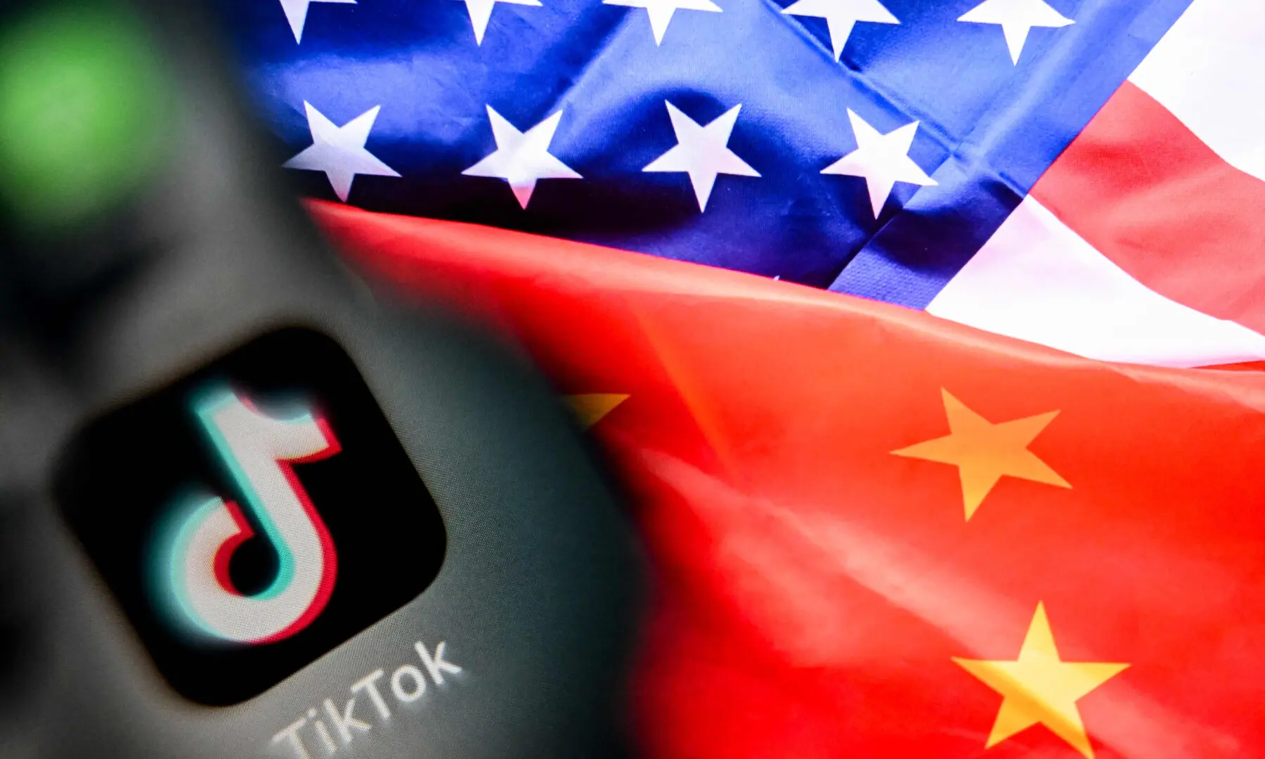 A photo taken on April 10, 2025 shows the Chinese social networking service TikTok&rsquo;s logo on a smartphone screen (L) and a US and China flag illustration on a laptop screen in Frankfurt am Main, western Germany. &mdash; AFP/File