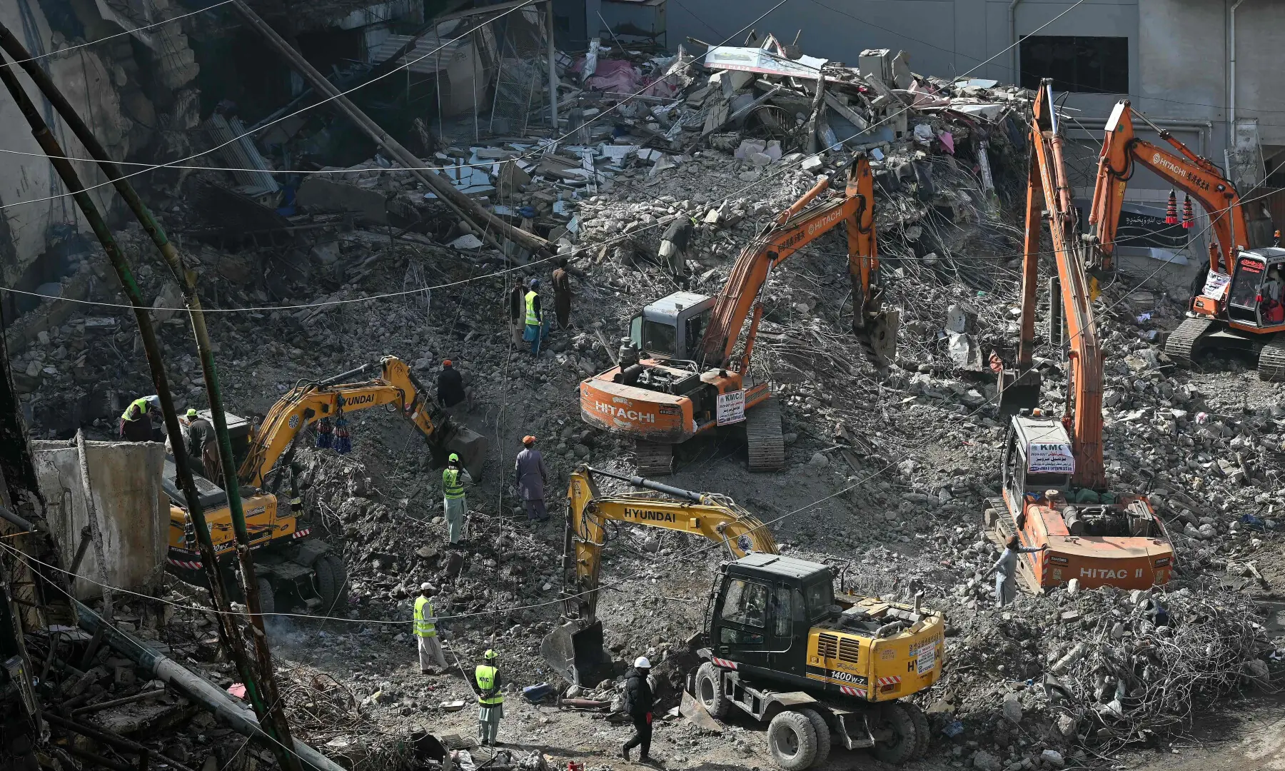 Rescue workers clear debris at the charred Gul Plaza shopping mall in Karachi on Jan 23, 2026. &mdash; AFP