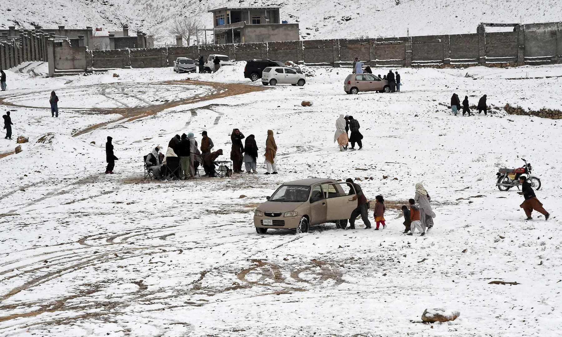 Locals gather and enjoy the snow on the outskirts of Quetta on January 22. &mdash; AFP