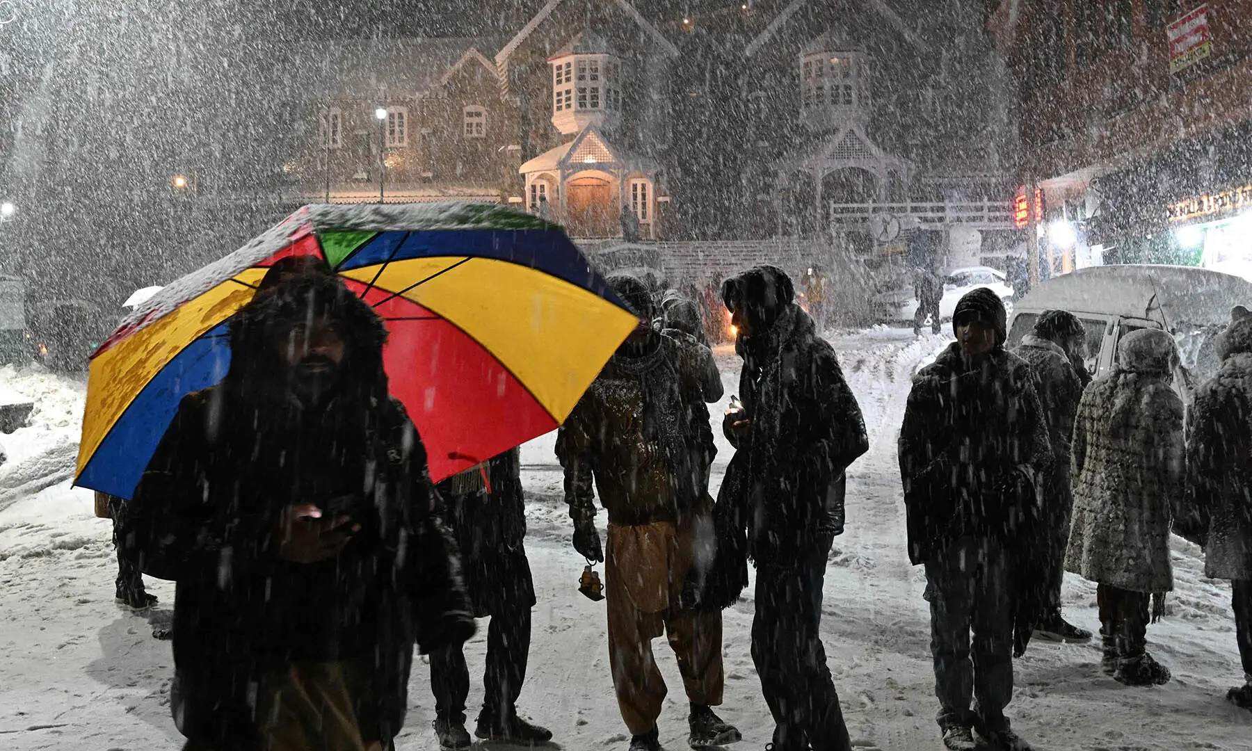 Tourists gather during a snowstorm in Murree on January 23. &mdash; AFP