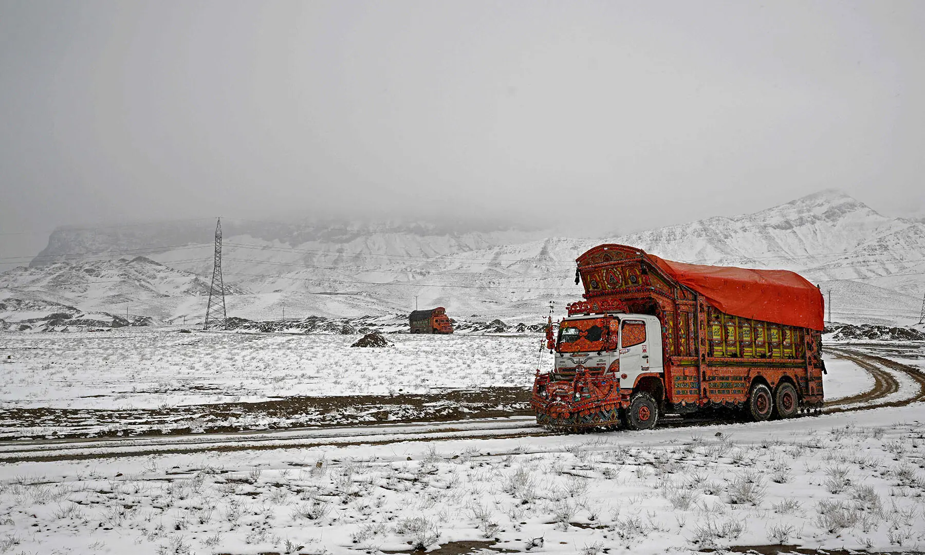 A truck drives through a snow-covered area on the outskirts of Quetta on January 22. &mdash; AFP
