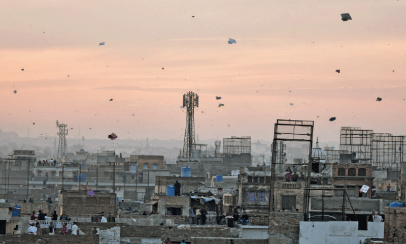 In this file photo, people fly kites in the Chittian Hattian area of Rawalpindi. &mdash; Photo by Khurram Amin/File